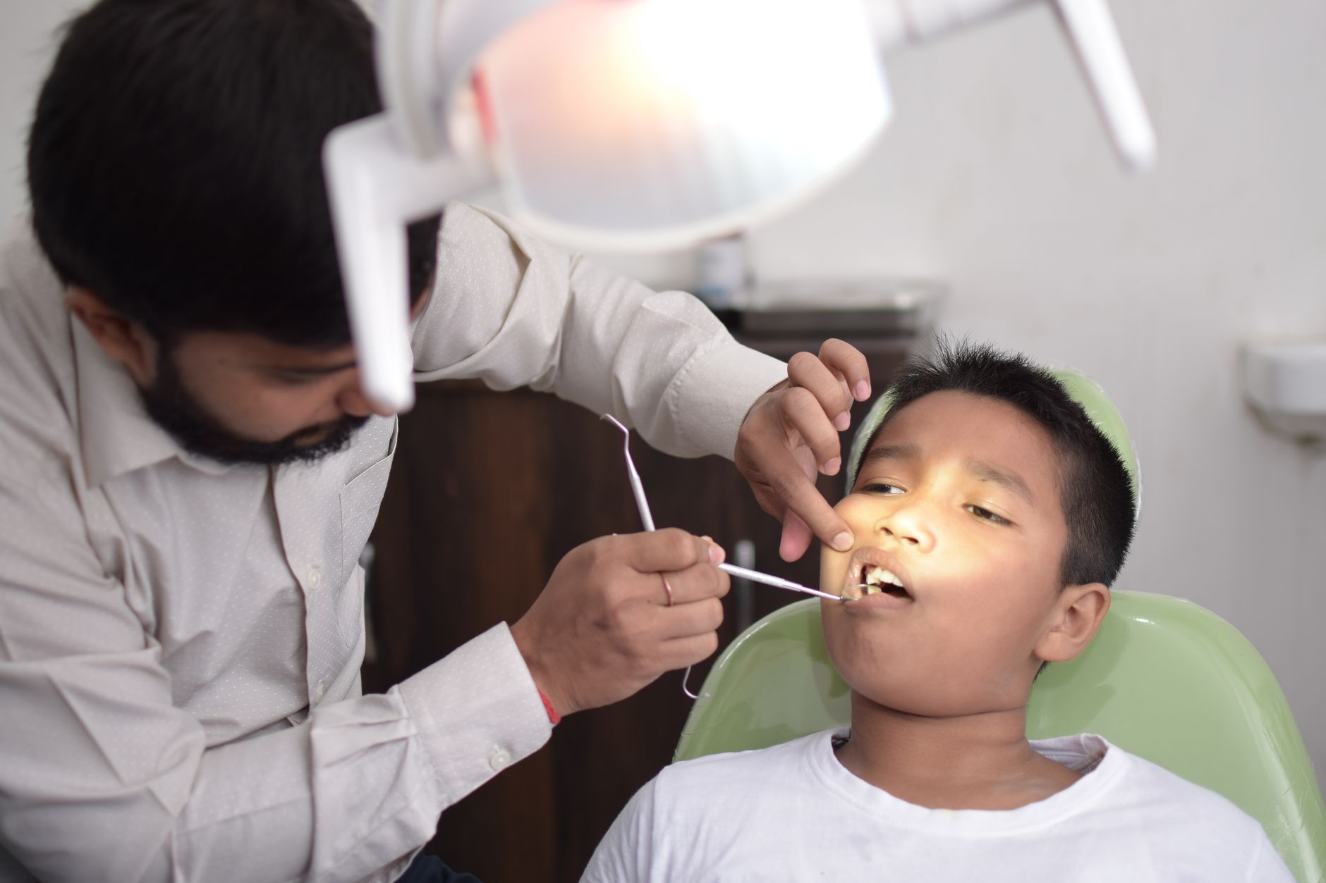 A young boy having a gentle dental checkup in the chair